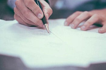 A man signs paperwork