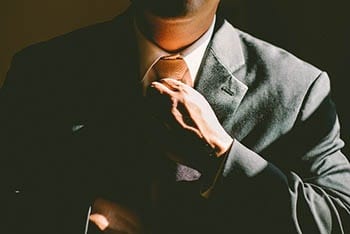 A man straightens his tie