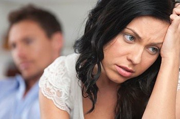 A woman looks disgusted with her husband