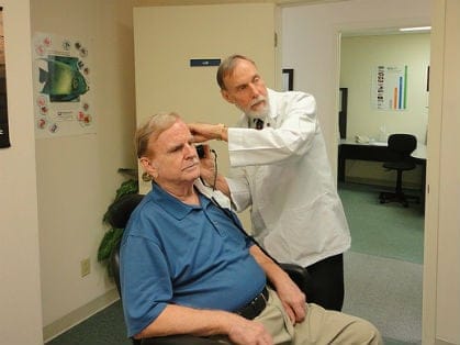 Man receiving a hearing test from a qualified medical professional