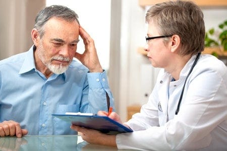 Man Speaking With Doctor About Cancers Associated With Military Radiation Exposure
