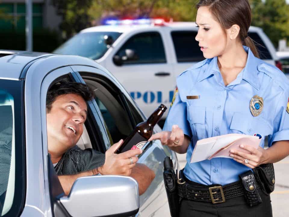 A drunk driver is pulling over with a female police officer