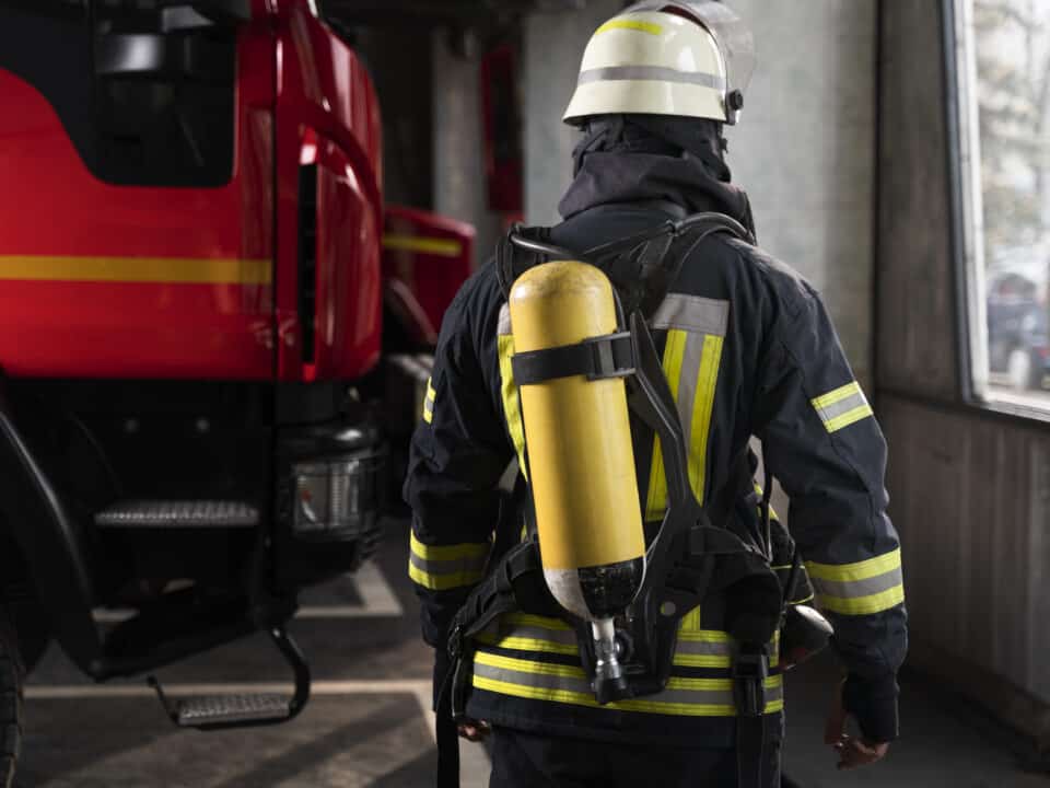 Firefighter at the station with suit and safety helmet