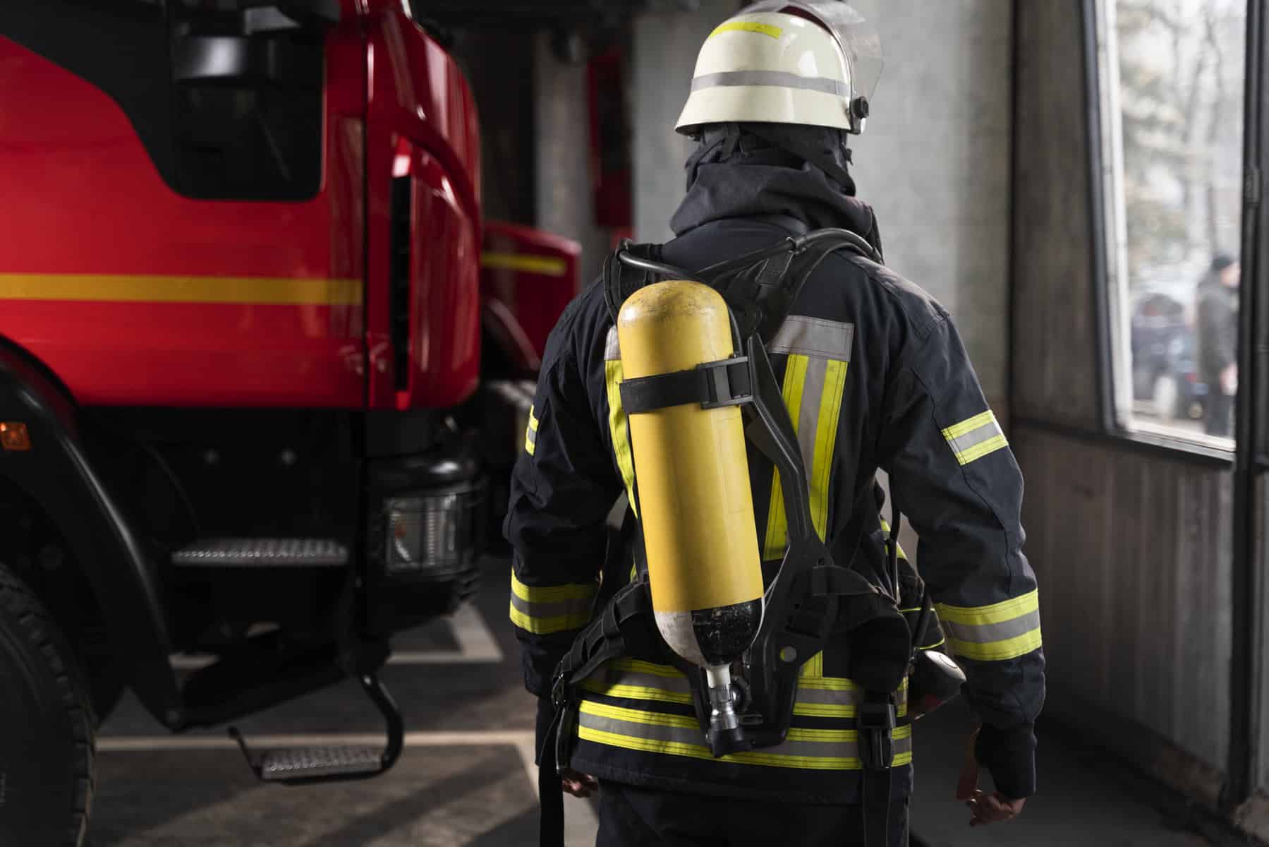 Firefighter at the station with suit and safety helmet